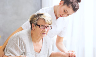 caregiver assisting senior woman