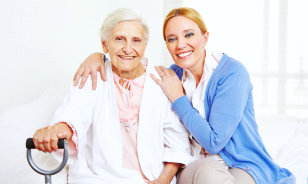 caregiver and senior woman smiling