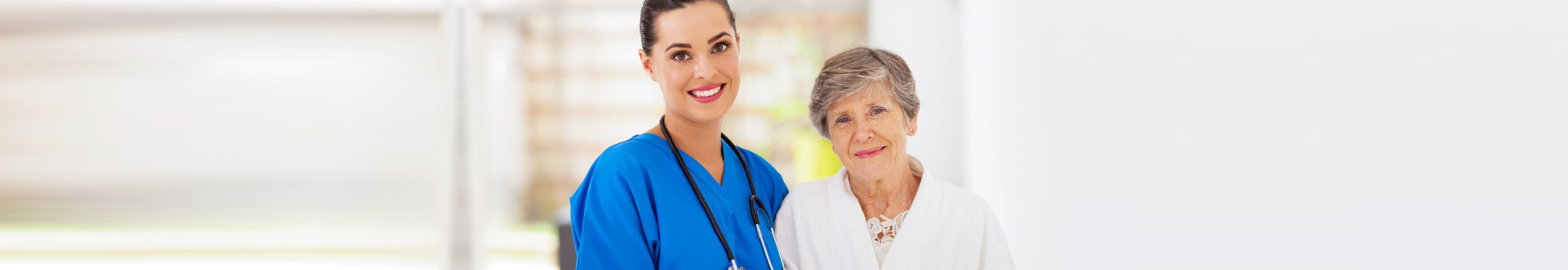 senior woman and nurse smiling