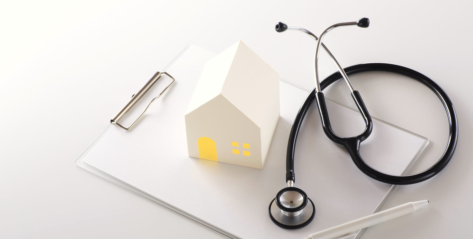 a pile of paper, shape house and stethoscope