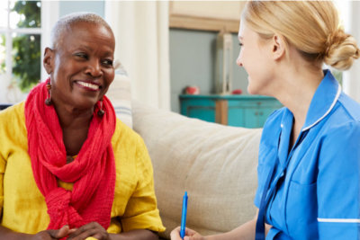 medical social worker talking with the senior woman smiling
