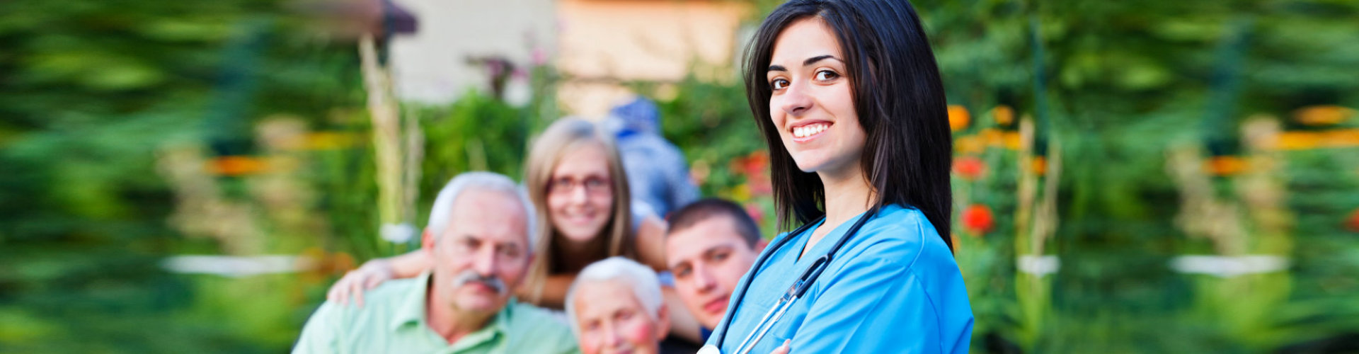 a nurse wearing stestescope and a happy family at the back smiling