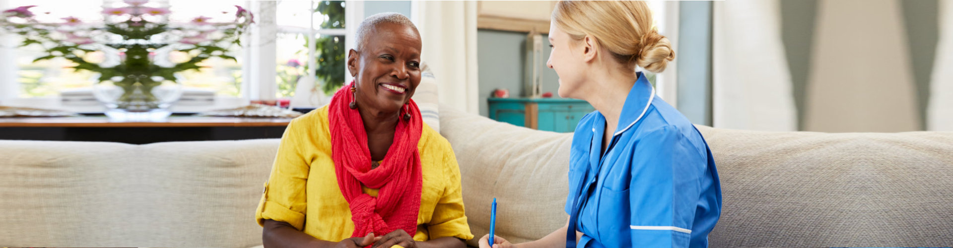 medical social worker talking with the senior woman smiling