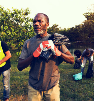 man carrying a plastic bag 