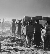 people carrying something on their head