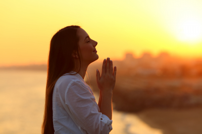 a portrait of a woman praying