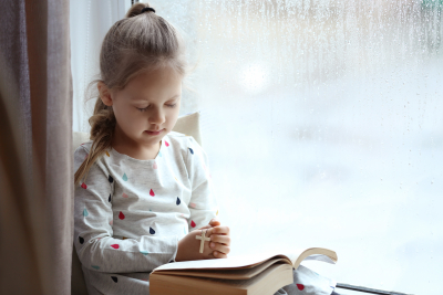 Religious Christian girl praying over Bible