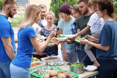 Volunteers serving food for people