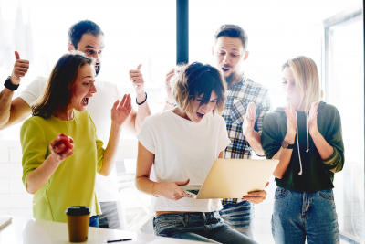 Team of successful student is celebrating the receiving of positive answer