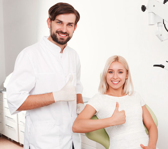 Portrait of smiling dentist and patient