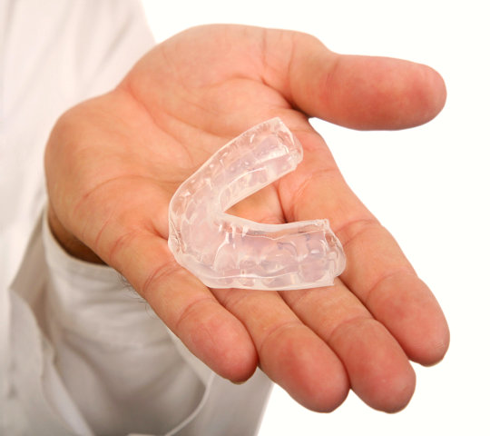 Doctor Presenting a Mouth Guard