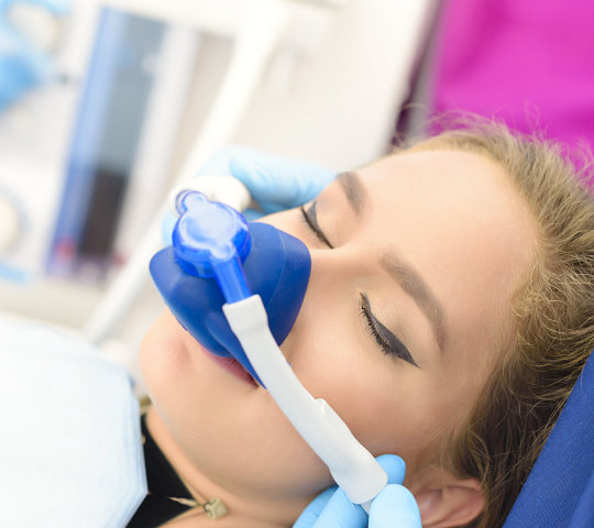 woman getting inhalation sedation at dental clinic