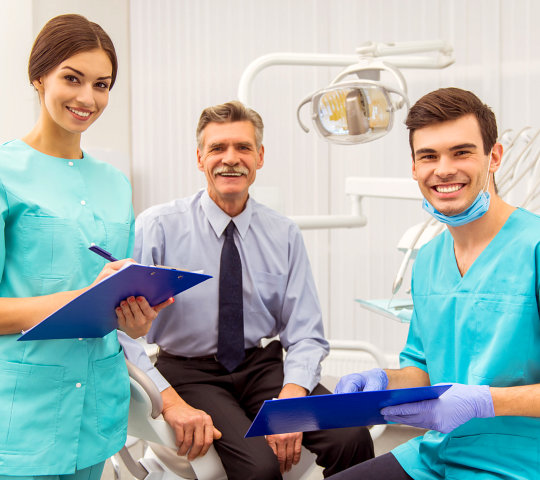 Young doctor dentist and his assistant recording in the documents