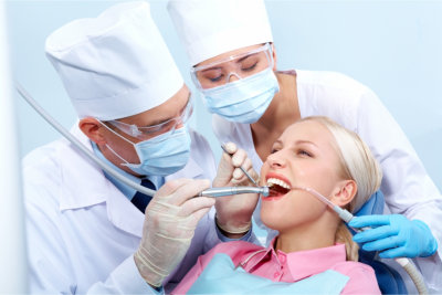 Image of dentist treating woman's teeth