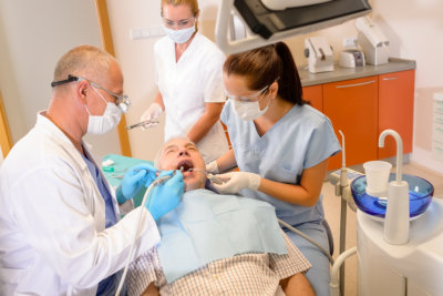 Senior at dentist surgery having teeth checkup