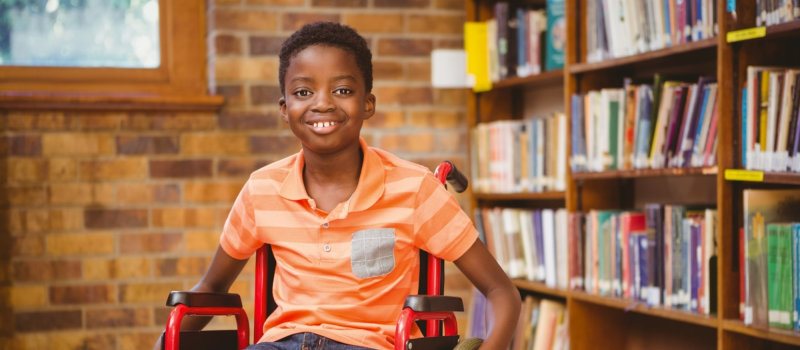kid in wheelchair smiling